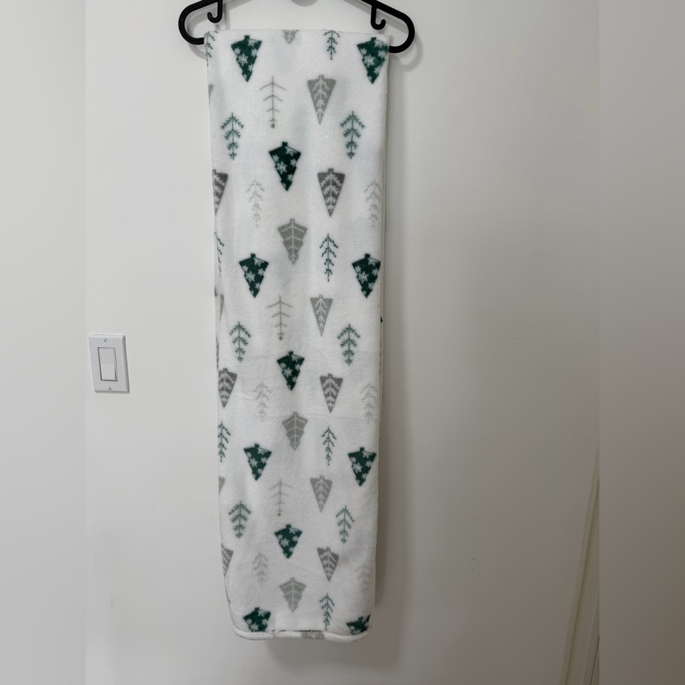 White fleece throw blanket with green and gray Christmas tree pattern